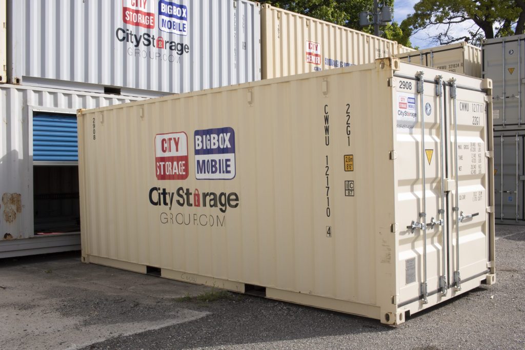 branded shipping container in front of collection of non- branded bins with locked end visible