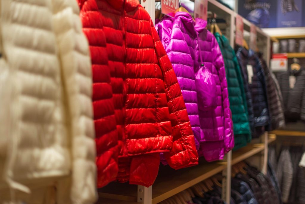 Seasonal items, winter coats, hung for retail purposes.