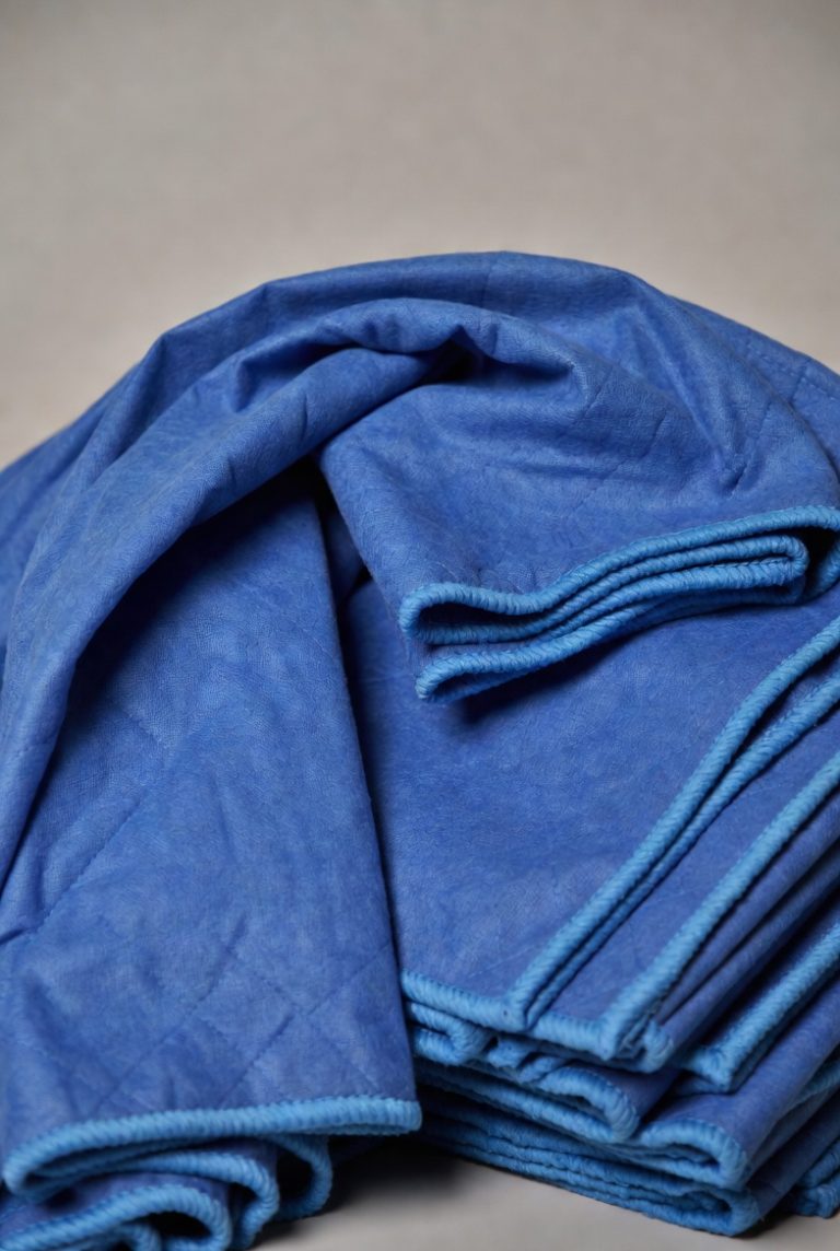 A pile of blue packing blankets.